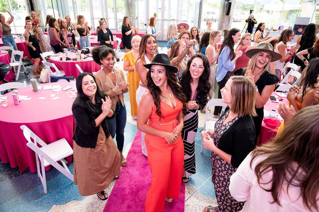 A happy group of women applauding during a social event party at The Cable Center